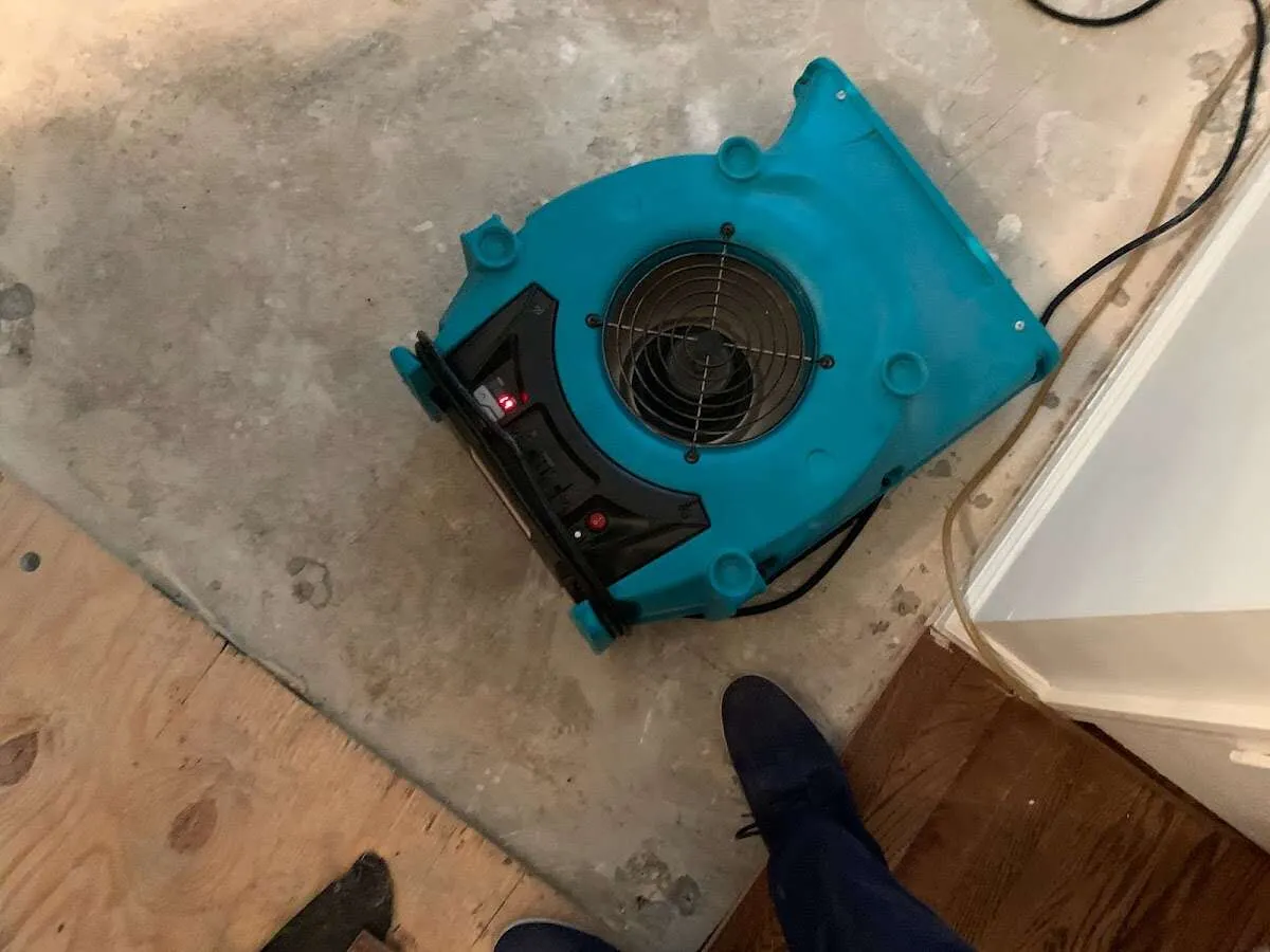 Air mover drying subfloor during Leak Detection & Repair in Boonville